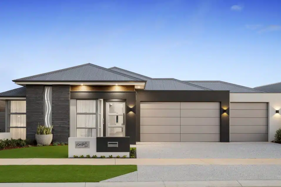 A modern home with a dark and light color scheme, three-car garage, and stylish architectural design.